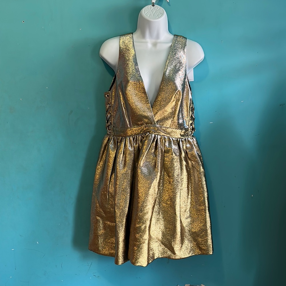 Cocktail dress. Never work. Size 3 with tags. Metallic gold low cut